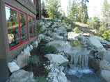 Meandering water feature with natural boulders