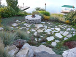 Flagstone in grass with fire pit and natural ground cover