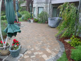 Red paver patio with gray stone border