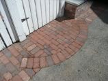 Red clay paver accent at the garden gate