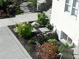 Stone paver patio with natural rock window encasement