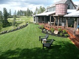Manicured lawn from covered porch with outdoor seating