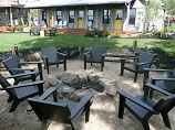 Outdoor seating around open firepit with scenic overview