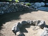 Rock Ring firepit with curved retaining wall