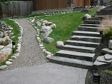 Lighted gravel walkway up with stone steps