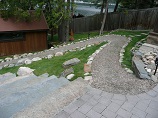 Paver patio with stone steps and gravel walkway