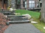 Paver pathway with landscape lighting and stone steps