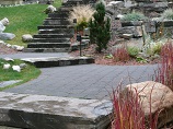 Paver pathway with natural rock steps and landscape lighting