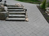 Lighted stone steps and paver pathway