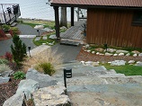 Stone stairway and lighted pathway down to deck and dock
