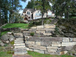 Multiple tiers of drystacked retaining walls and steps