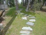 Rock stairway and path placed in grass