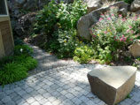 Gravel path leading away from stone paver walkway