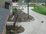 Paver walkway with flower beds and raised garden beds