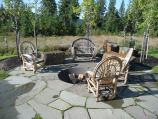Natural stone patio, inset firepit with boulder seating