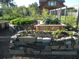 Wood and stacked stone garden beds