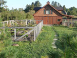Fenced garden and flagstone walkway to the barn
