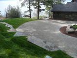 Raised lawn with paver driveway