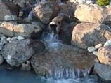Natural stone waterfall mixed with river rock