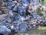 Tri-tier natural boulder waterfall into a collection pond